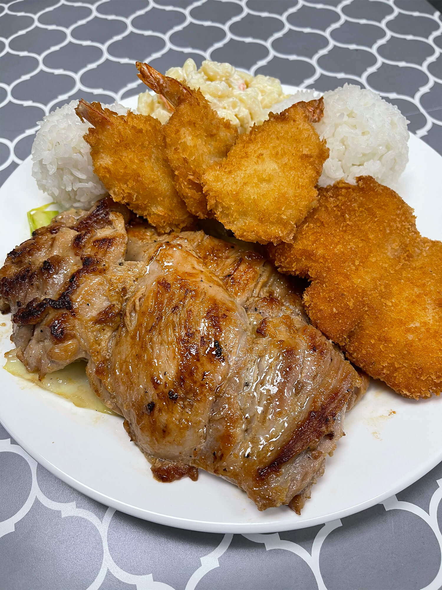 Aloha-Hawaiian-BBQ-&-Sushi-Asian-Fusion-restaurant-Grilled-Pork-and-Fried-Shrimp-Plate-Baldwin-Park Grilled pork and fried shrimp served with rice and potato salad Sushi burrito with chicken, avocado, and vegetables at Aloha Hawaiian BBQ & Sushi, a Asian Fusion restaurant in Baldwin Park