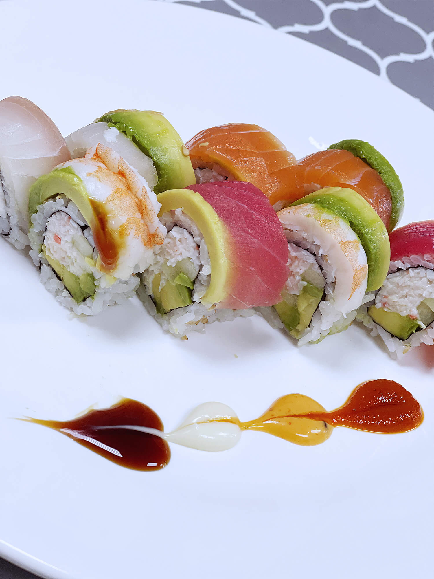 Aloha-Hawaiian-BBQ-&-Sushi-Asian-Fusion-restaurant-Assorted-Sushi-Platter-Baldwin-Park Sushi platter with various fresh fish, avocado, and colorful sauces at Aloha Hawaiian BBQ & Sushi, a Asian Fusion restaurant in Baldwin Park